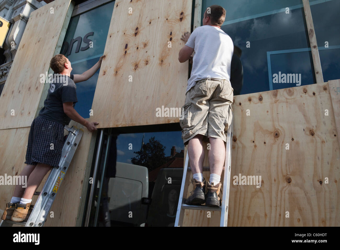 Shopkeepers boarding up their shops in Muswell Hill, North London Stock Photo