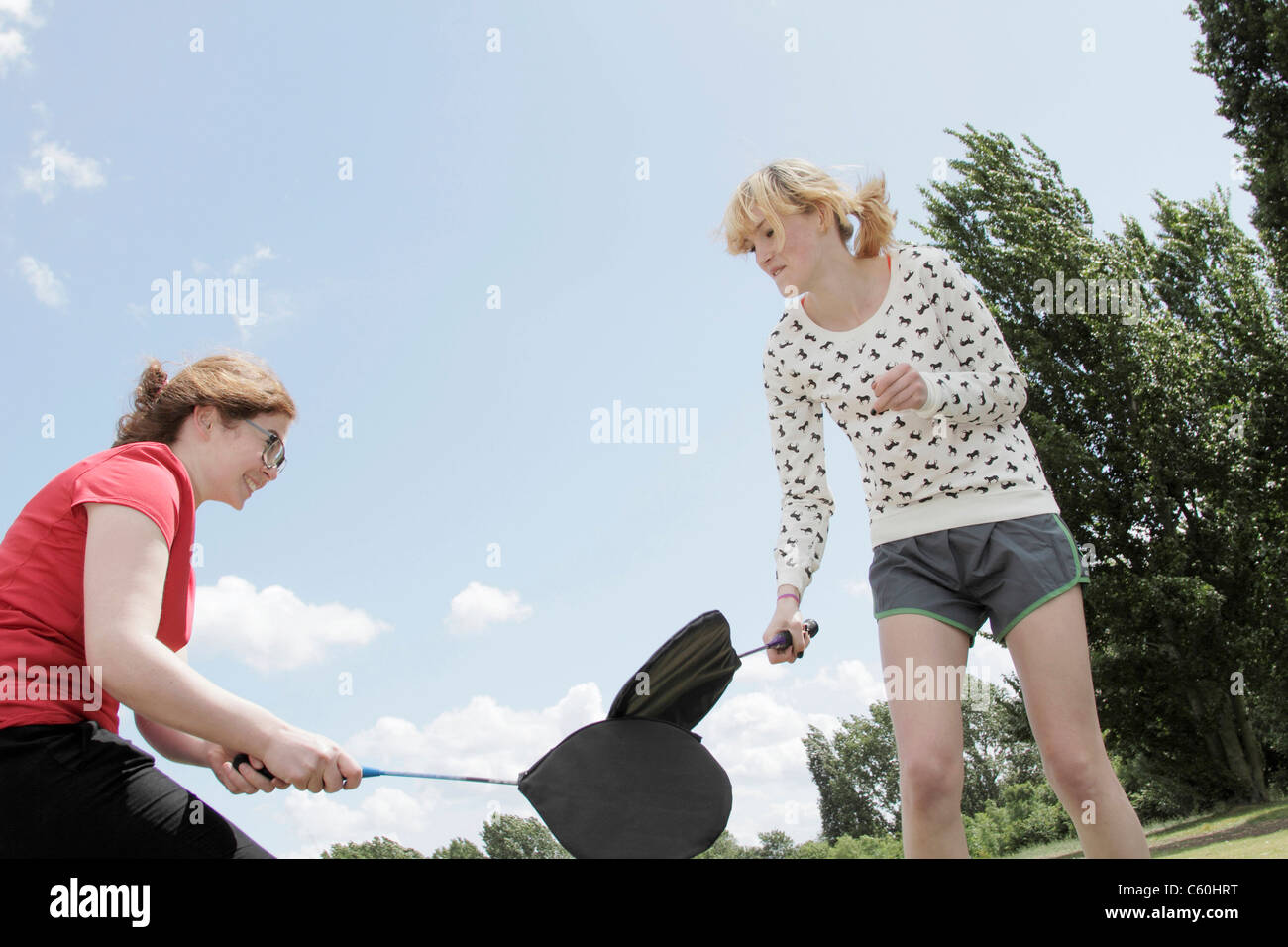 Girls playing with rackets in park Stock Photo