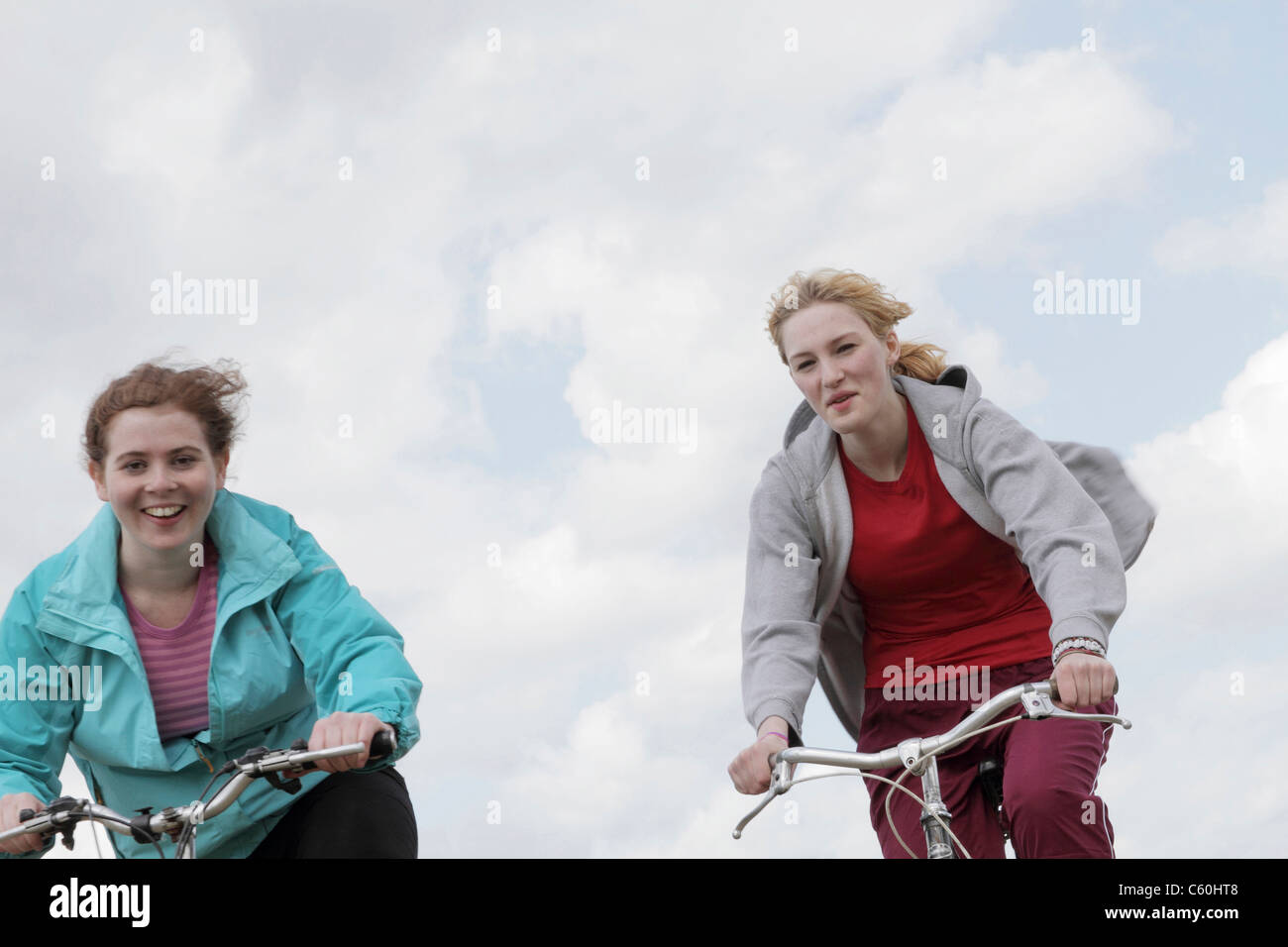 Girls riding bikes outdoors Stock Photo