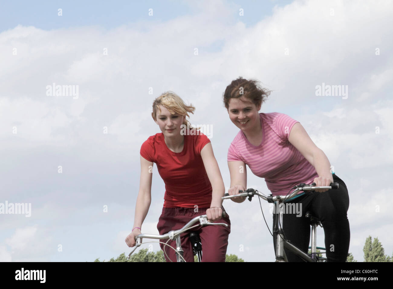 Girls riding bikes outdoors Stock Photo