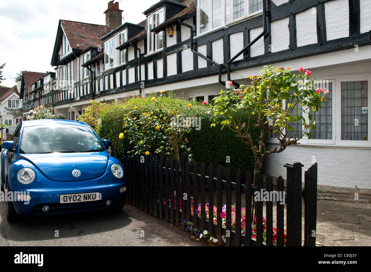 Street with row of houses and new Volkswagen beetle car, Bray, Berkshire, England, UK Stock Photo