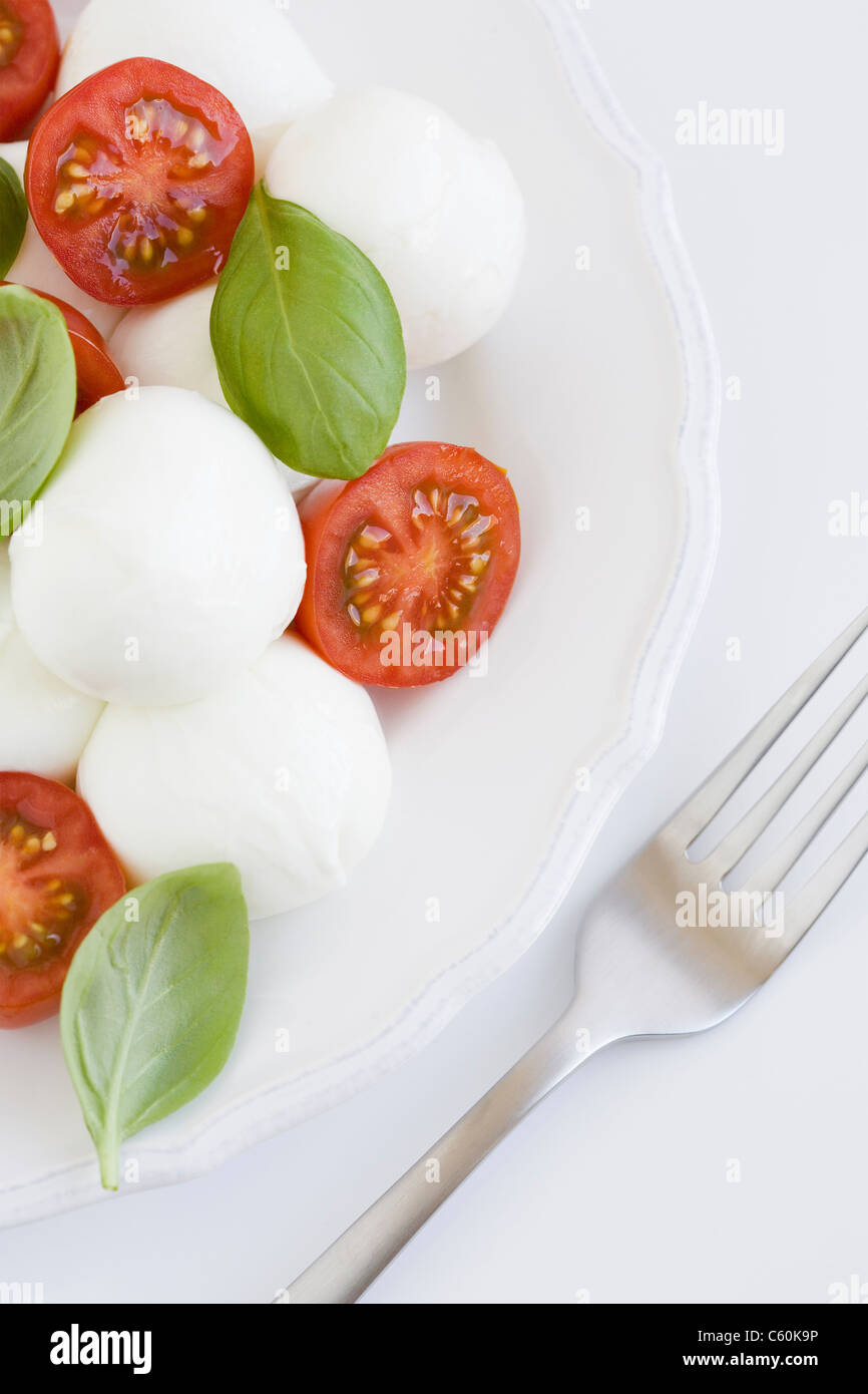 Plate of mozzarella, tomatoes and basil Stock Photo