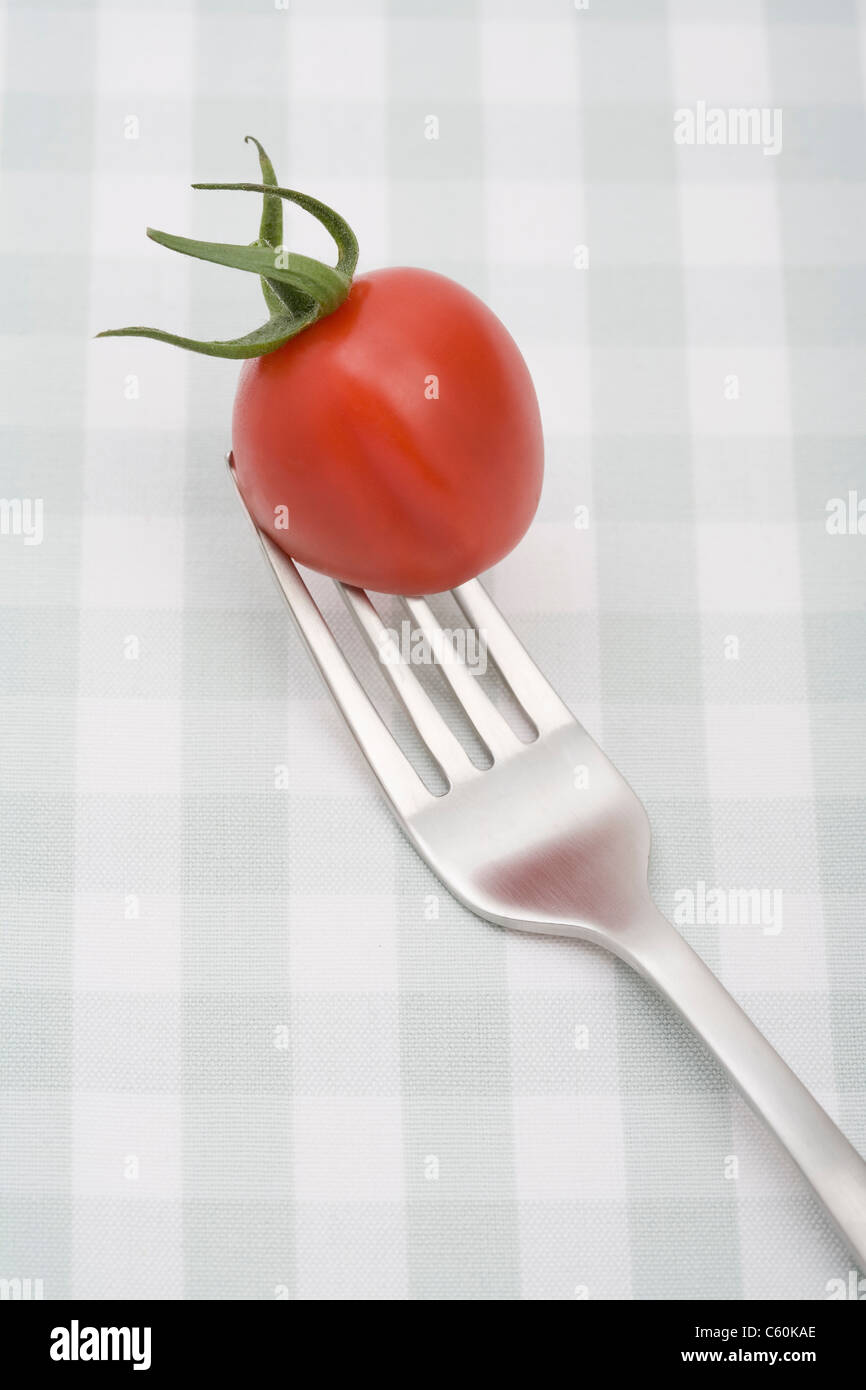 Close up of cherry tomato on fork Stock Photo
