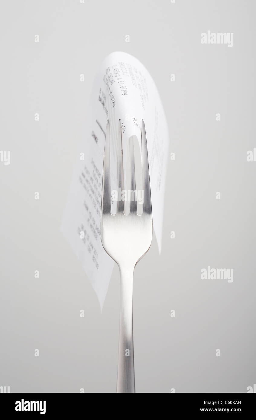 Close up of receipt on fork Stock Photo