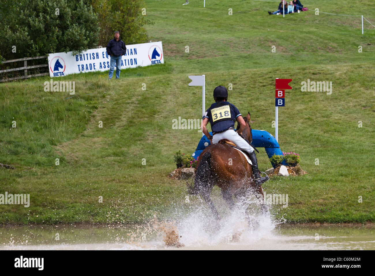 Horse and rider in the lake  on the cross-country at the British Festival of eventing at Gatcombe Park in Gloucestershire Stock Photo