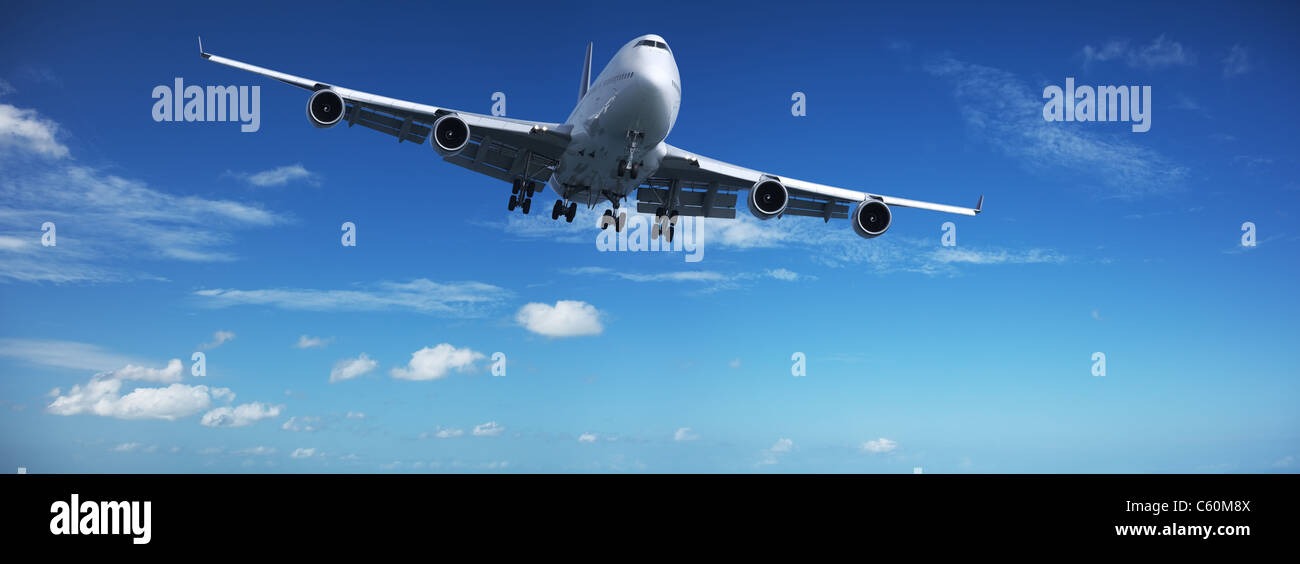 Jet in a blue sky. Panoramic composition Stock Photo Alamy