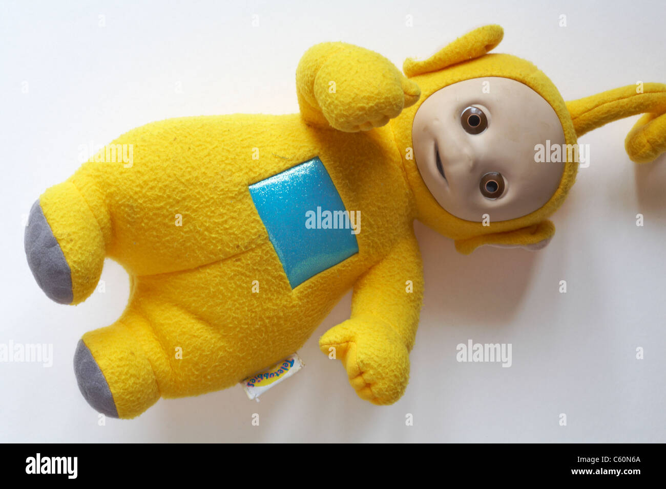 Well loved cuddly Laa-Laa teletubby doll on white background Stock Photo