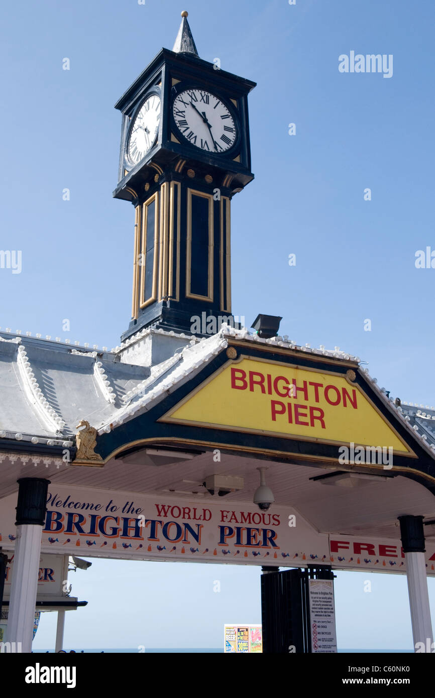 Brighton Palace Pier East Sussex entrance welcome sign signs clock tower welcome pillar pillars Stock Photo