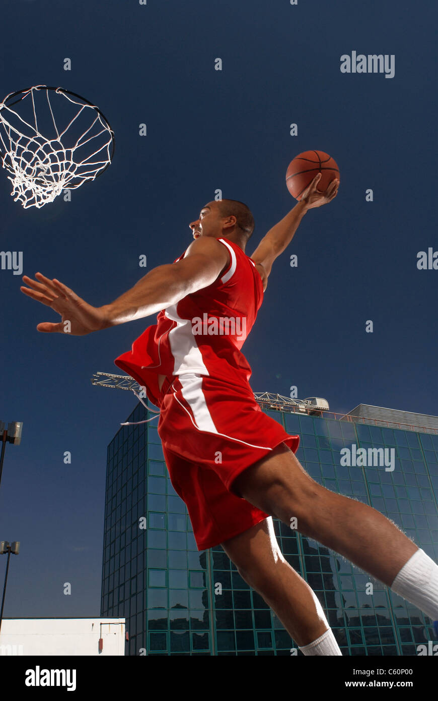 Basketball player about to dunk Stock Photo