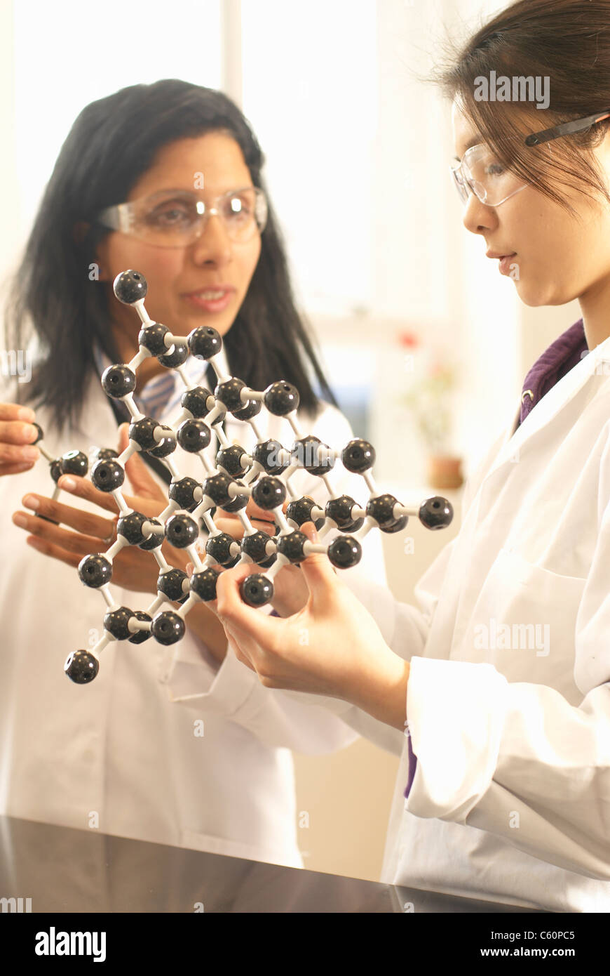 Scientists examining molecular model Stock Photo Alamy
