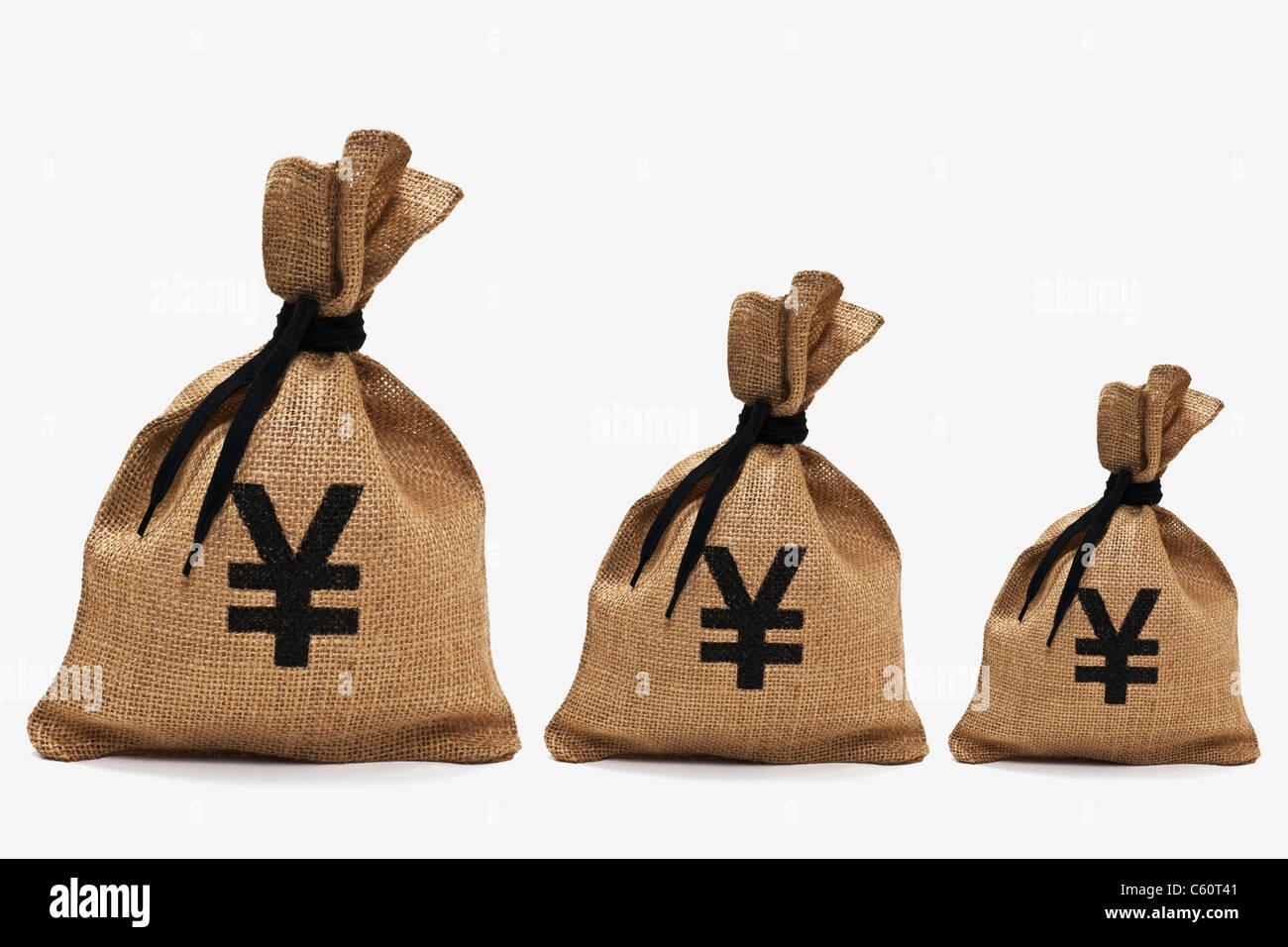 three different big money bags with yen sign next to each other Stock Photo