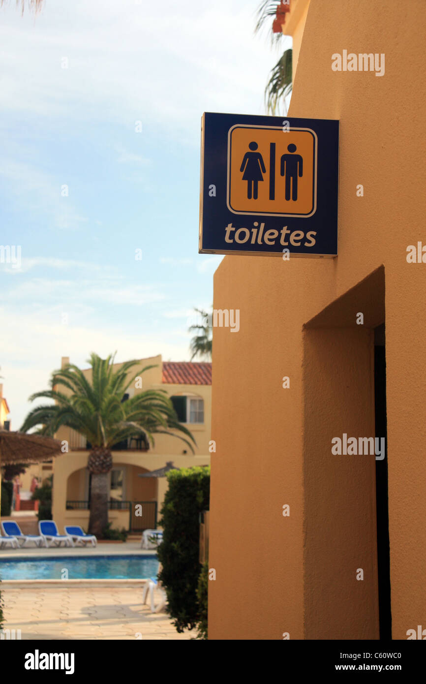 A sign for the toilets in spanish in Menorca Stock Photo Alamy