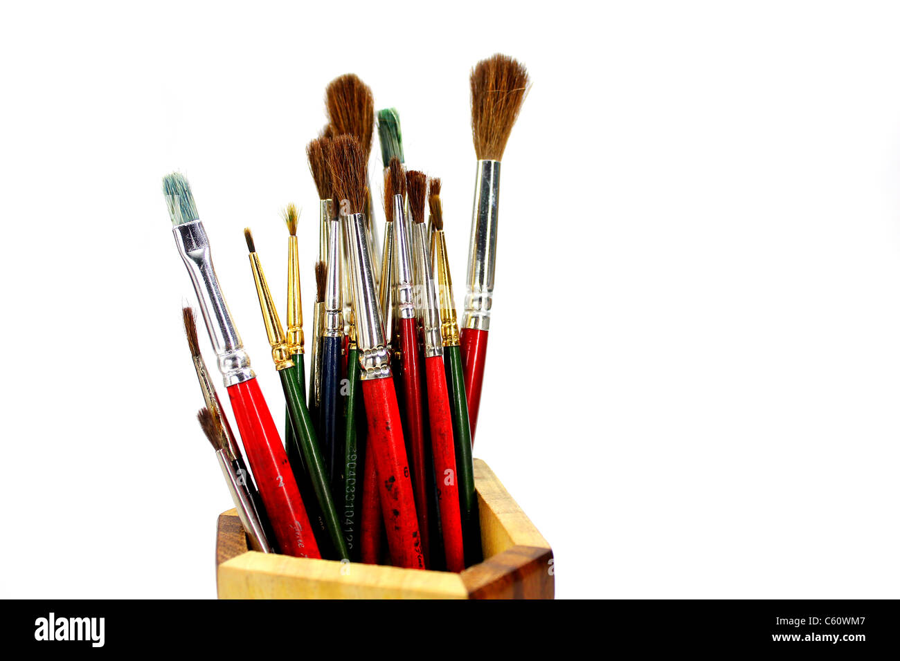 paint brushes in wooden stand isolated white background Stock Photo - Alamy