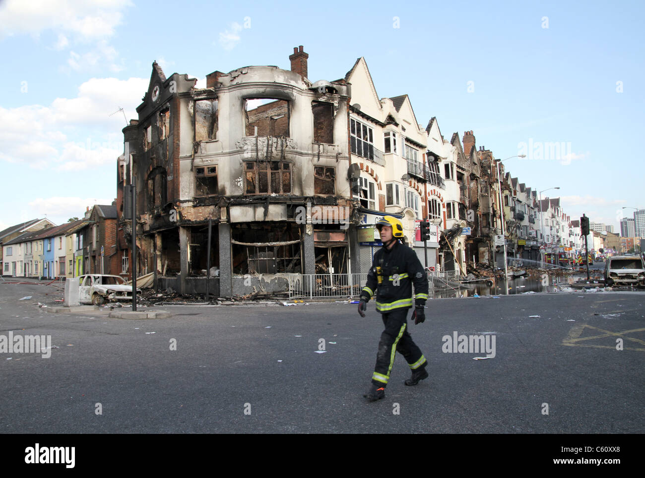 Firefighter inspects damage to shops, houses and property after riots ...