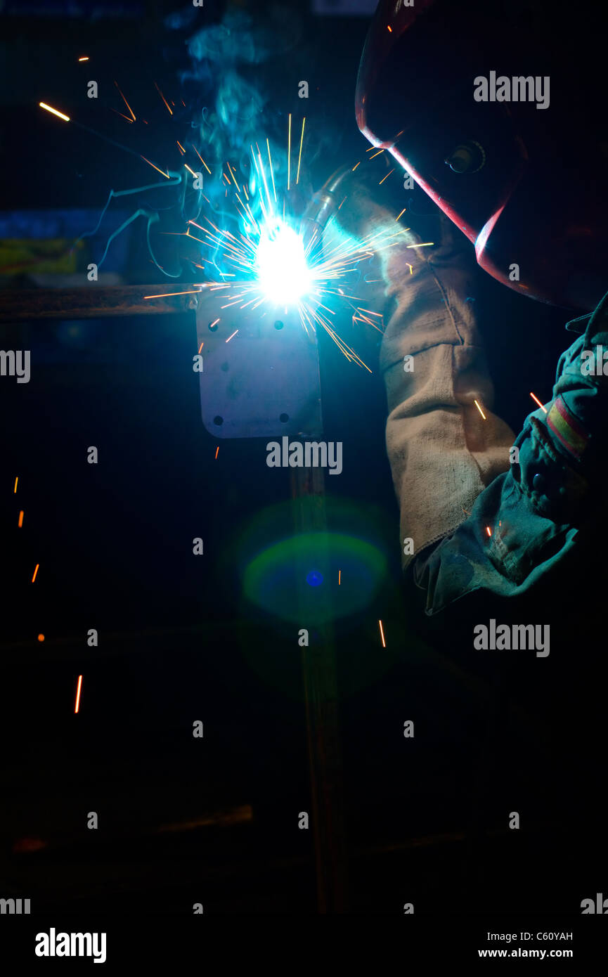 Photo of a welding process with sparks flying around Stock Photo