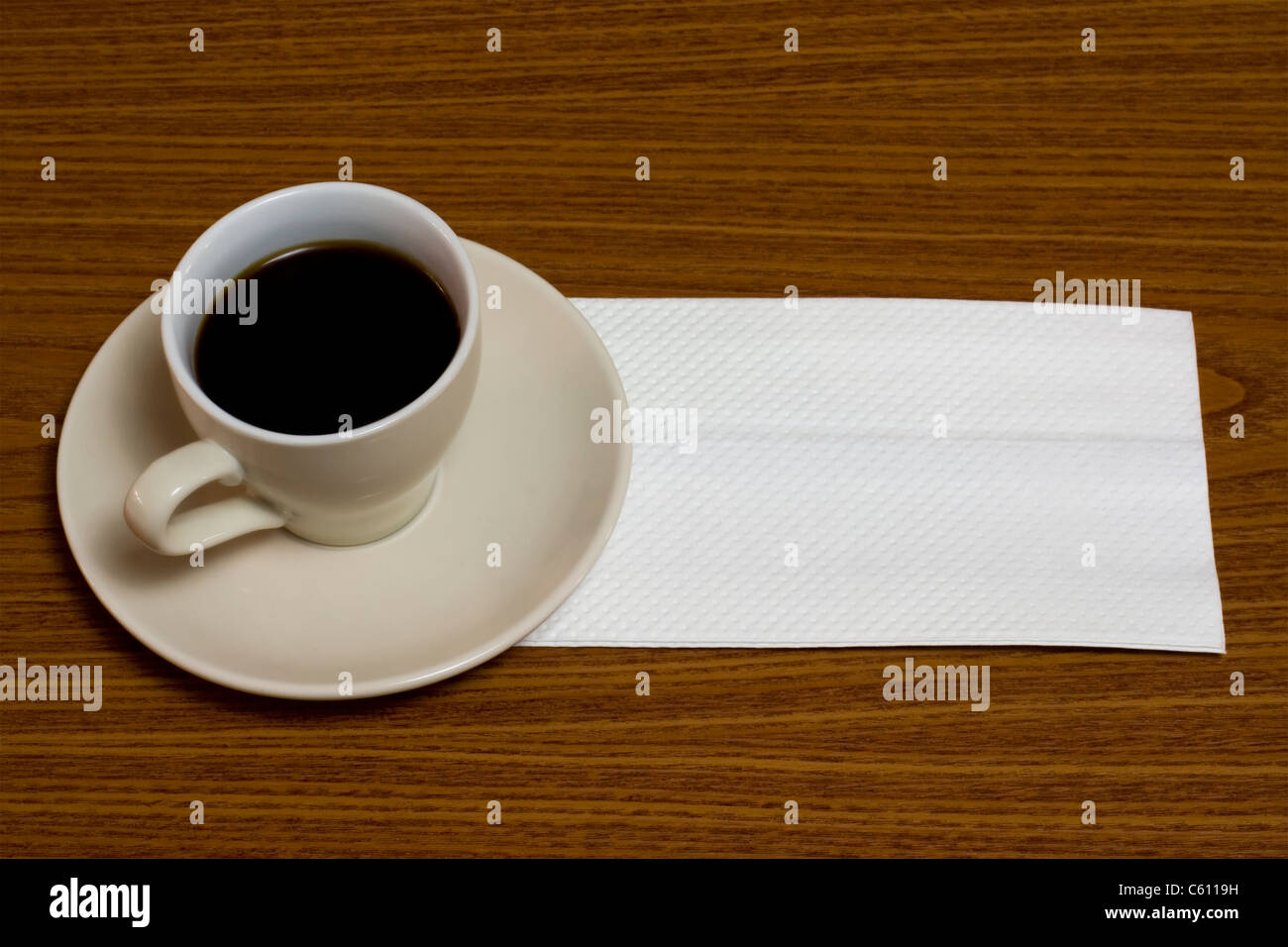 A cup of coffee with napkin on a table Stock Photo