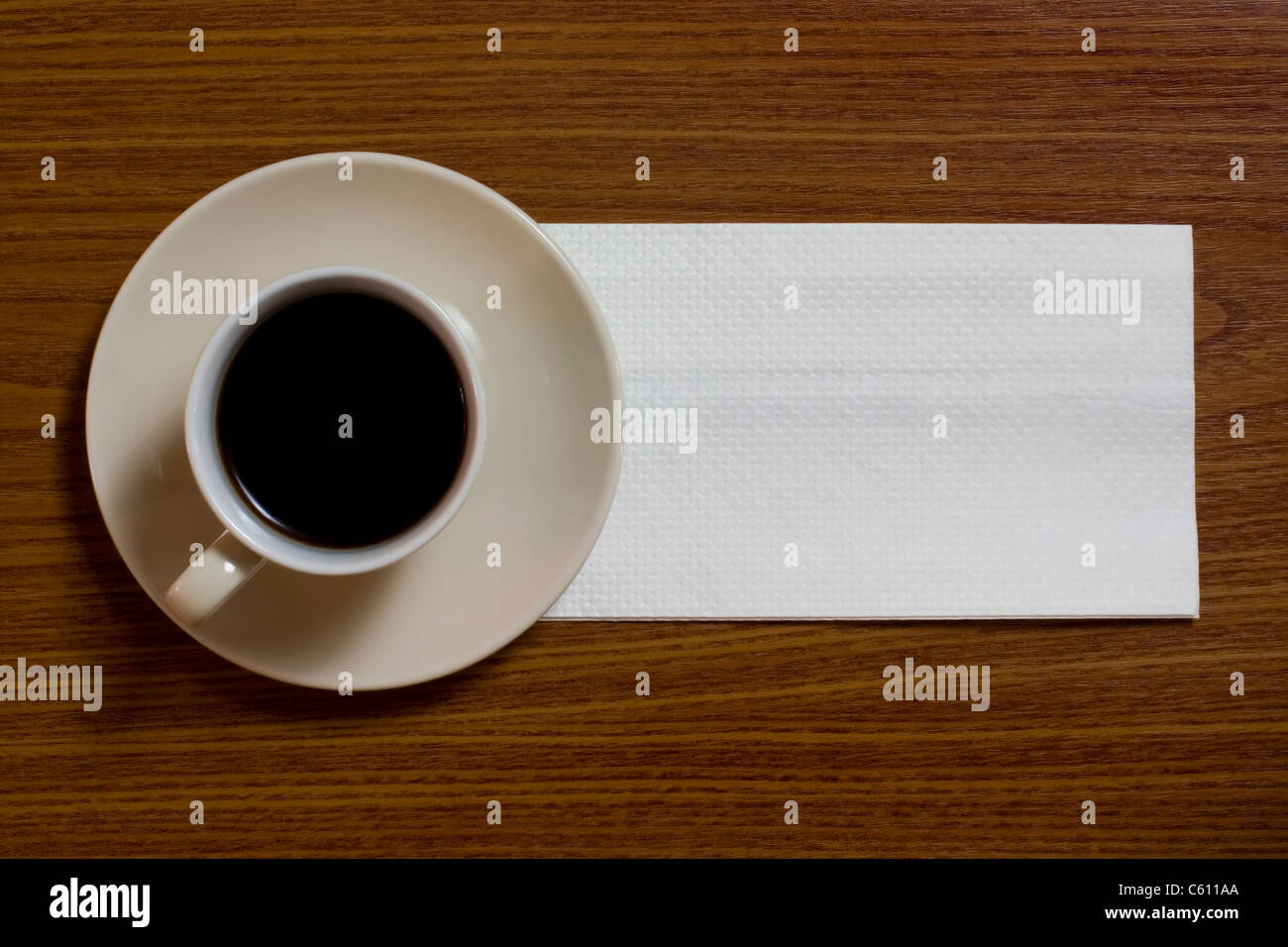 A cup of coffee with napkin on a table Stock Photo