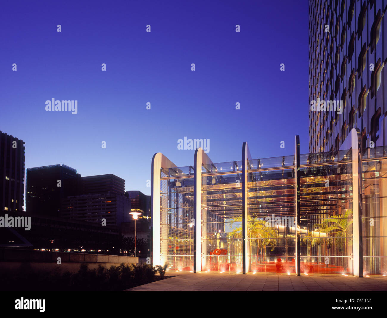 Paris business district at dawn with illuminated office lobby. Stock Photo