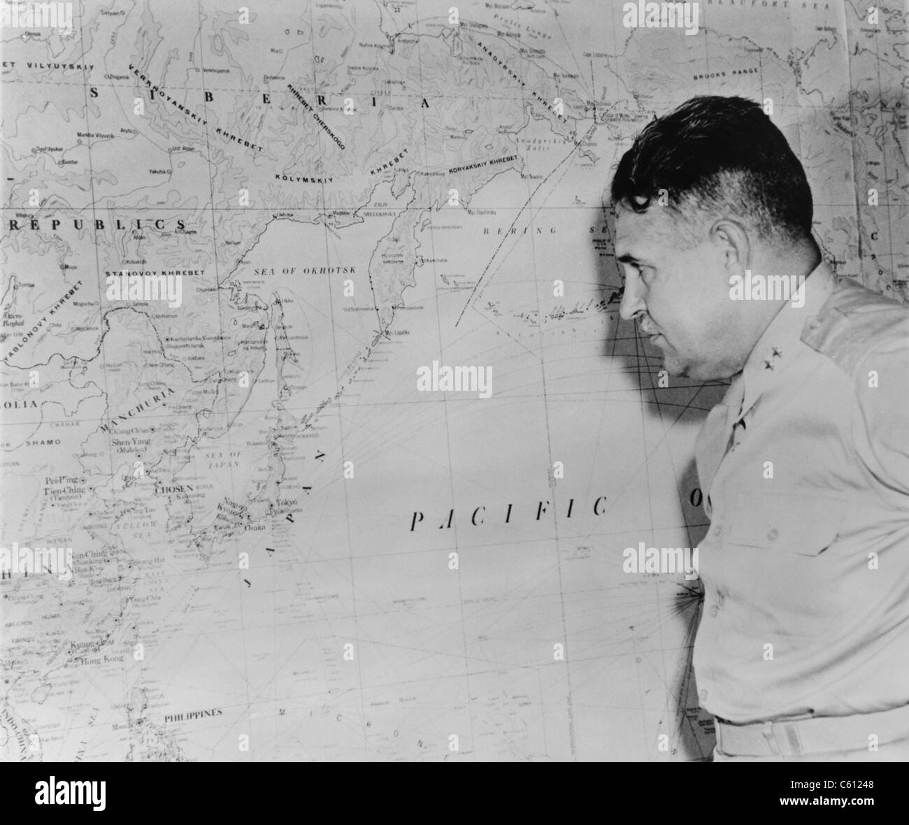 Major General Leslie Richard Groves, viewing a wall map of coastal East Asia and Japan, after the first use of the Atomic bomb against civilian targets in Hiroshima and Nagasaki. August 1945. Groves was played by Paul Newman in the 1989 movie, FAT MAN AND LITTLE BOY Stock Photo