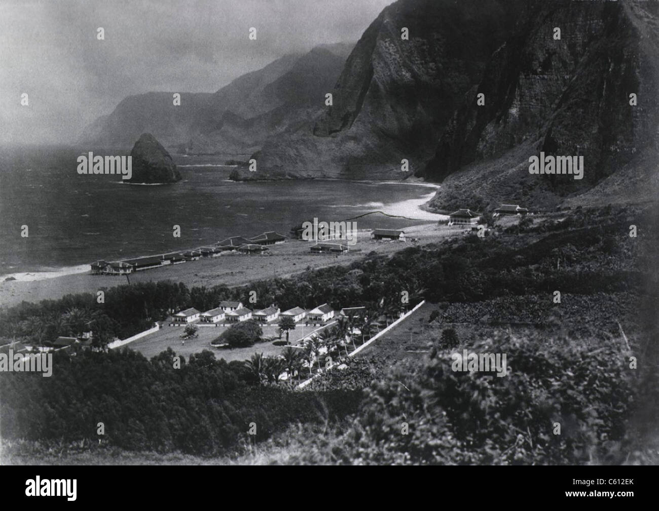 Leper Colony. The Kalawao Settlement, on the small Hawaiian island of Molokai, was established in 1866 as the first isolation settlement for Lepers. View of the Photo shows a circa 1900 view of the colony, showing buildings, ocean, and mountains. Kalawao is now part of Kalaupapa National Historic Park. Stock Photo