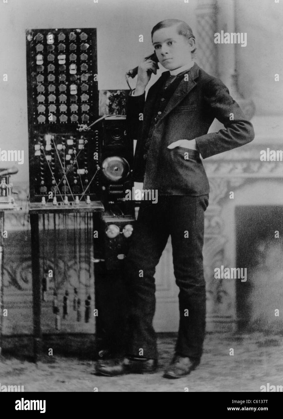 Less than ten years after Alexander Graham Bell's 1876 demonstration of the telephone, this young man worked as a long distance Stock Photo