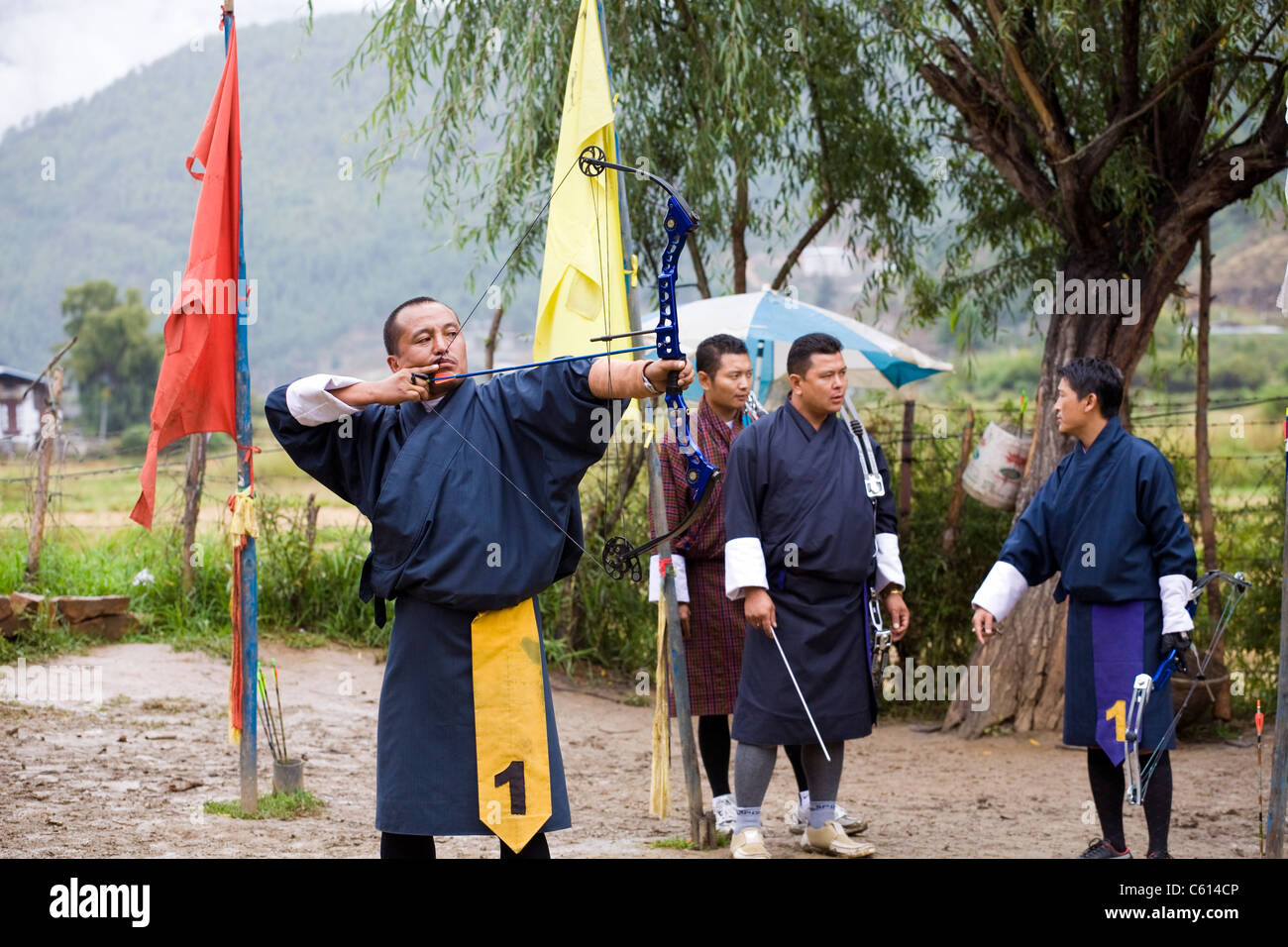 Bhutanese Archer aims at target during the local tournament in Paro. Bhutan Stock Photo