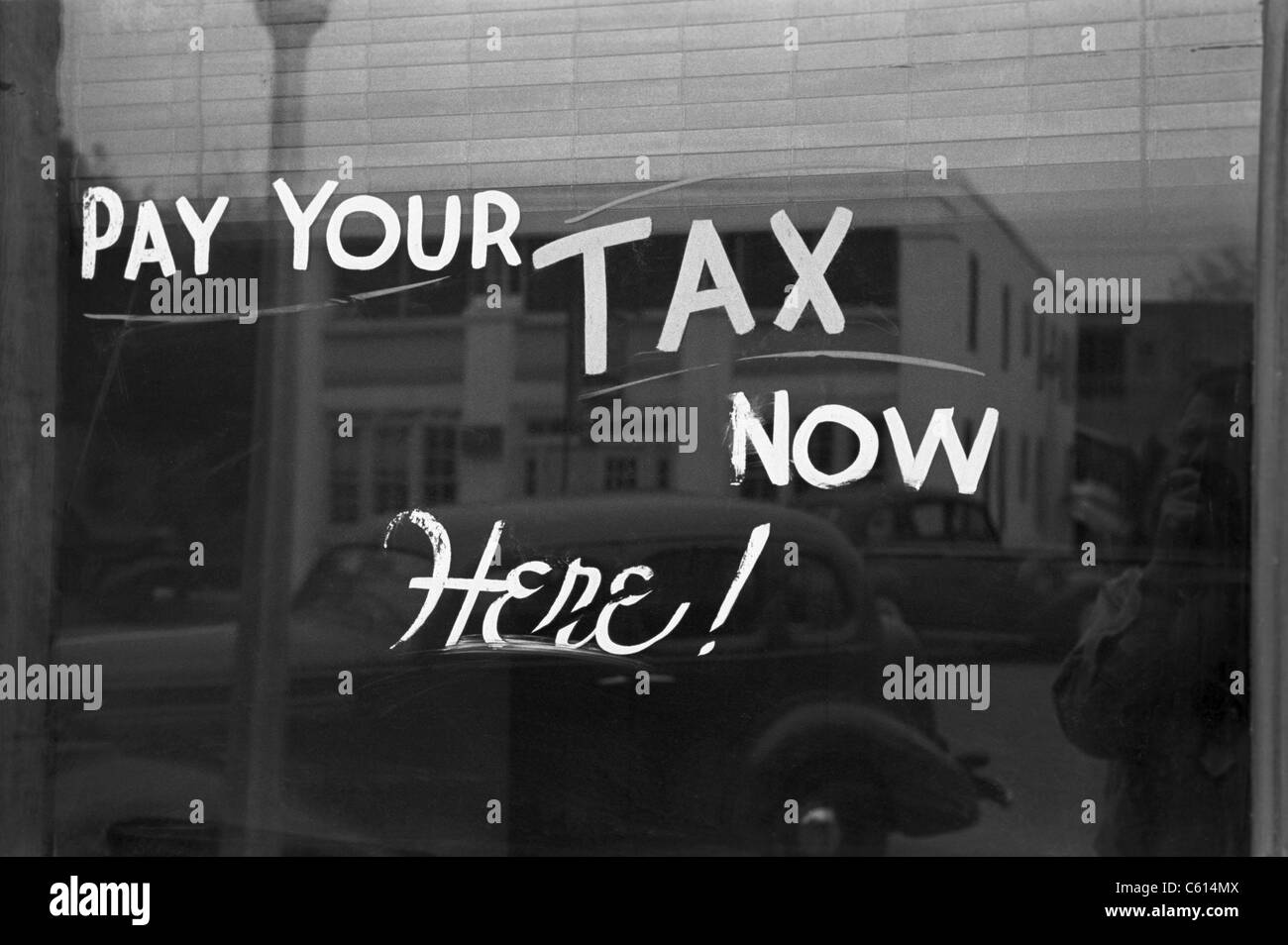 Sign reading PAY YOUR TAX NOW HERE in Harlingen Texas Feb. 1939 photo ...