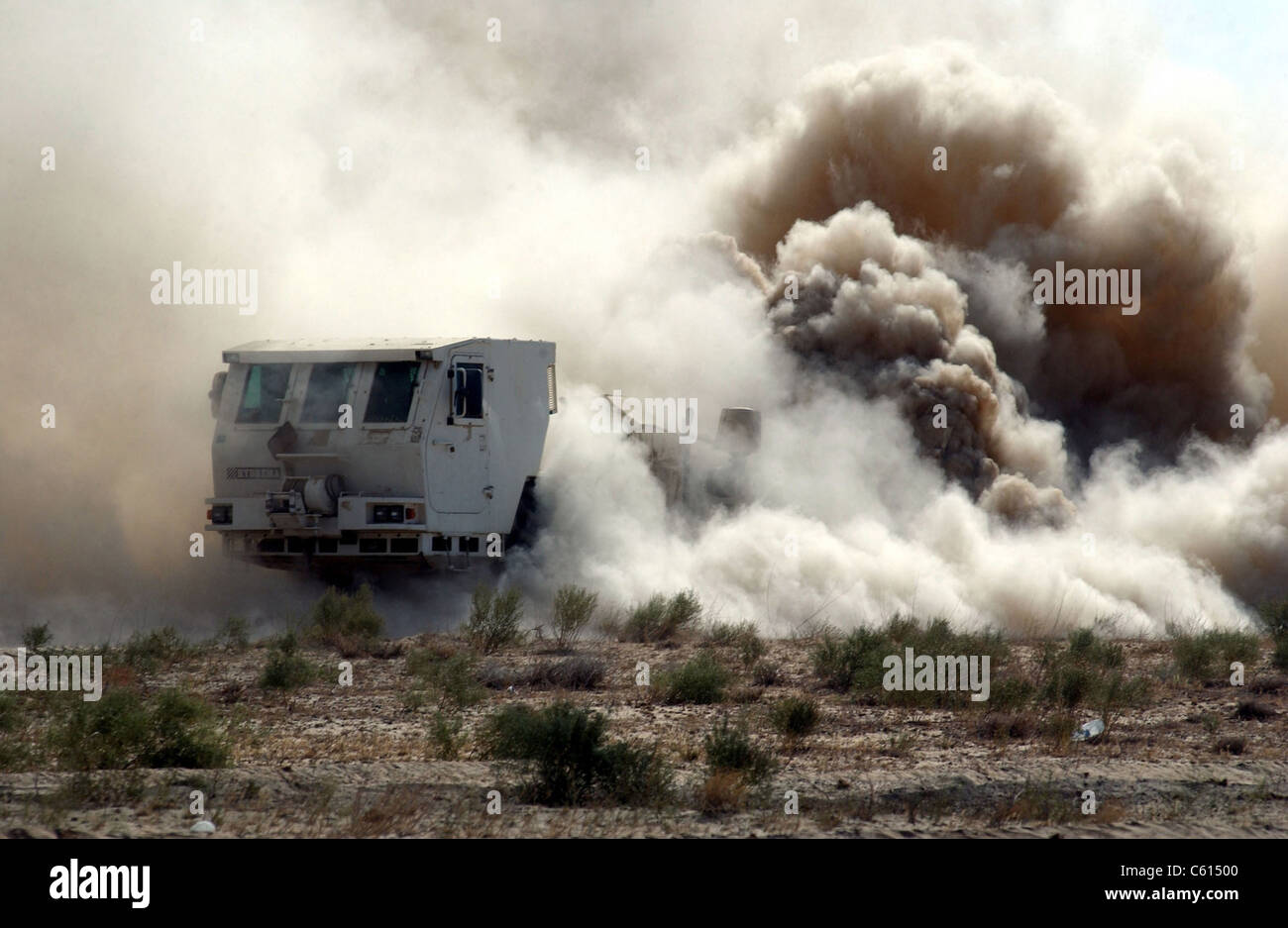 U.S. soldiers employ a mine clearing vehicle near the Bagram Air Base Afghanistan. The Hydrema a Danish made vehicle has a metal protective shield and heavy chains that flail to unearth destroy or detonate mines on contact. Aug. 24 2002., Photo by:Everett Collection(BSLOC 2011 6 34) Stock Photo