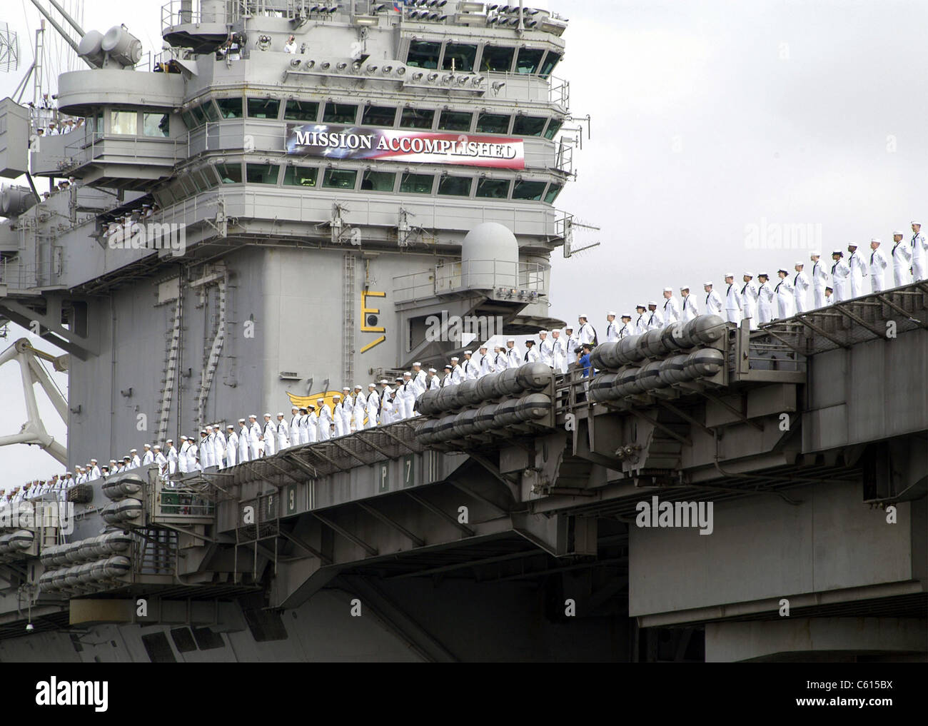 USS Abraham Lincoln arrives at San Diego returning from a 10-month deployment in Arabian Gulf. The 'Mission Accomplished' banner reflects early optimism that preceded seven years of insurgency following the 2003 invasion of Iraq. May 2 2003. (BSLOC 2011 12 136) Stock Photo