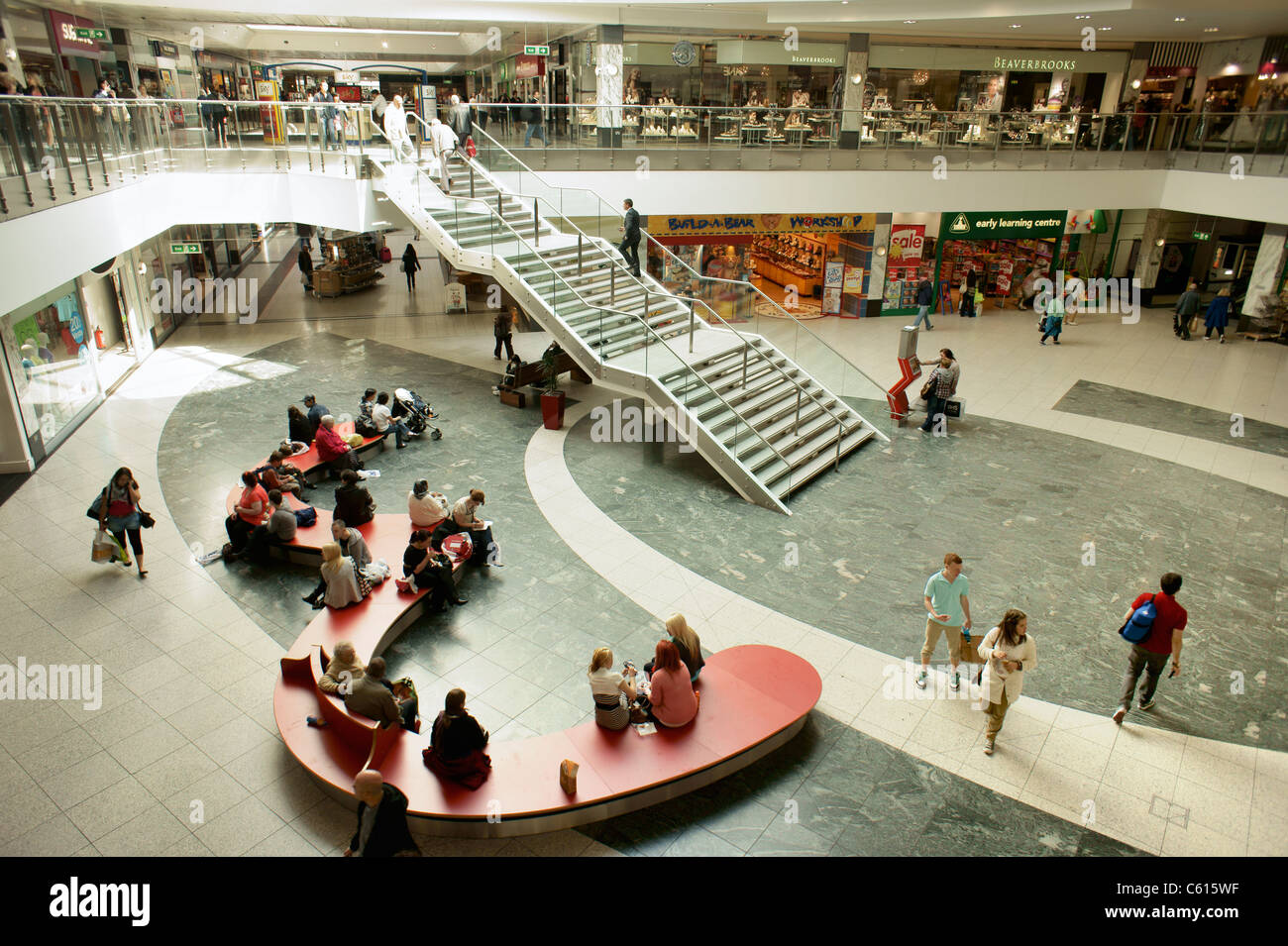 Arndale Centre, Manchester, England. Shoppers and retail outlet stores shops in the pedestrianised city centre shopping mall Stock Photo