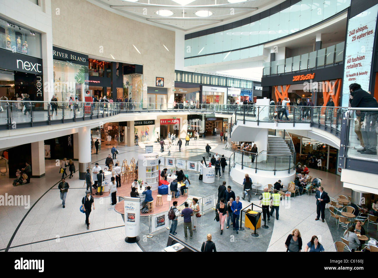 Arndale Centre, Manchester, England. Shoppers and retail outlet stores shops in the pedestrianised city centre shopping mall Stock Photo