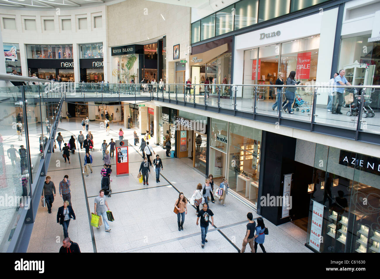 Arndale Centre, Manchester, England. Shoppers and retail outlet stores shops in the pedestrianised city centre shopping mall Stock Photo