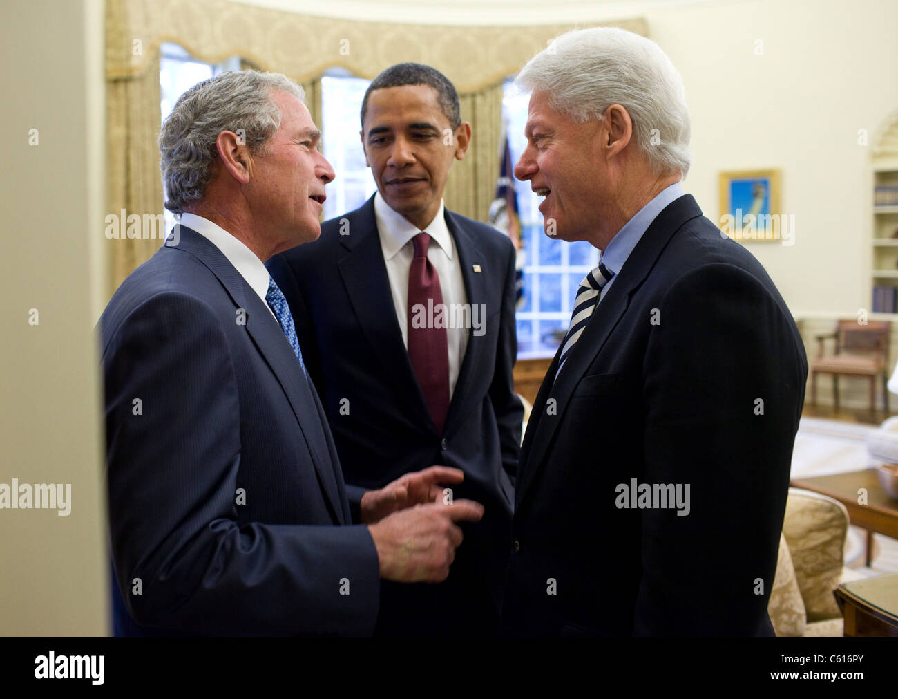 President Obama listens to a conversation between former Presidents Bill Clinton and George W. Bush after recruiting them to help earthquake stricken Haiti. Jan. 16 2010. (BSWH 2011 8 165) Stock Photo