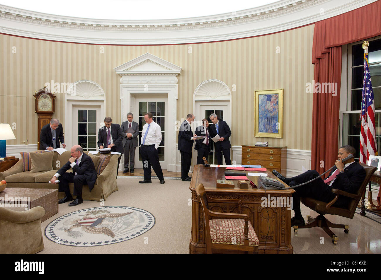 President Obama talks on the phone with Egyptian President Hosni Mubarak as senior staff and national security team listen and work in the background. Feb. 1 2011. (BSWH 2011 8 366) Stock Photo