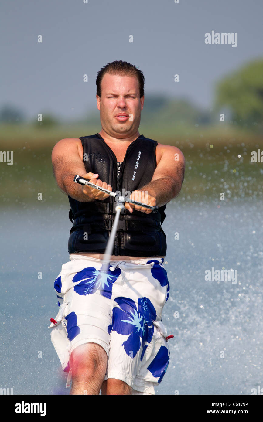 A close-up of a waterskier holding the tow rope. Stock Photo