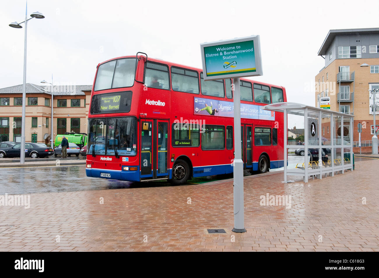 Red double decker bus in Metroline livery waiting at a bus stop at