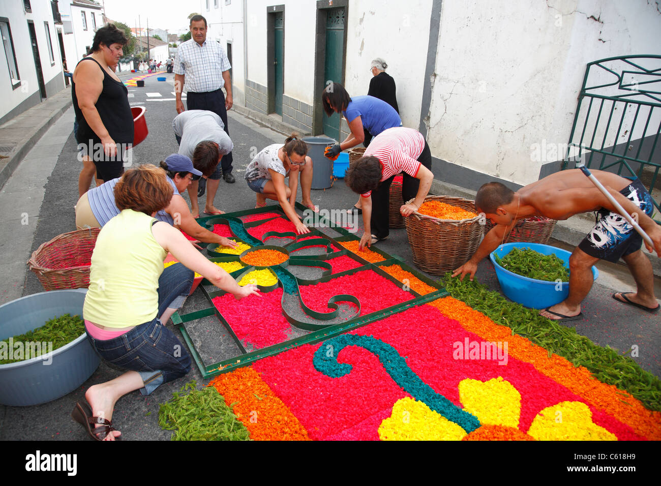 Local residents making flower carpets, in the parish of Ponta Garça. Sao Miguel island, Azores, Portugal Stock Photo
