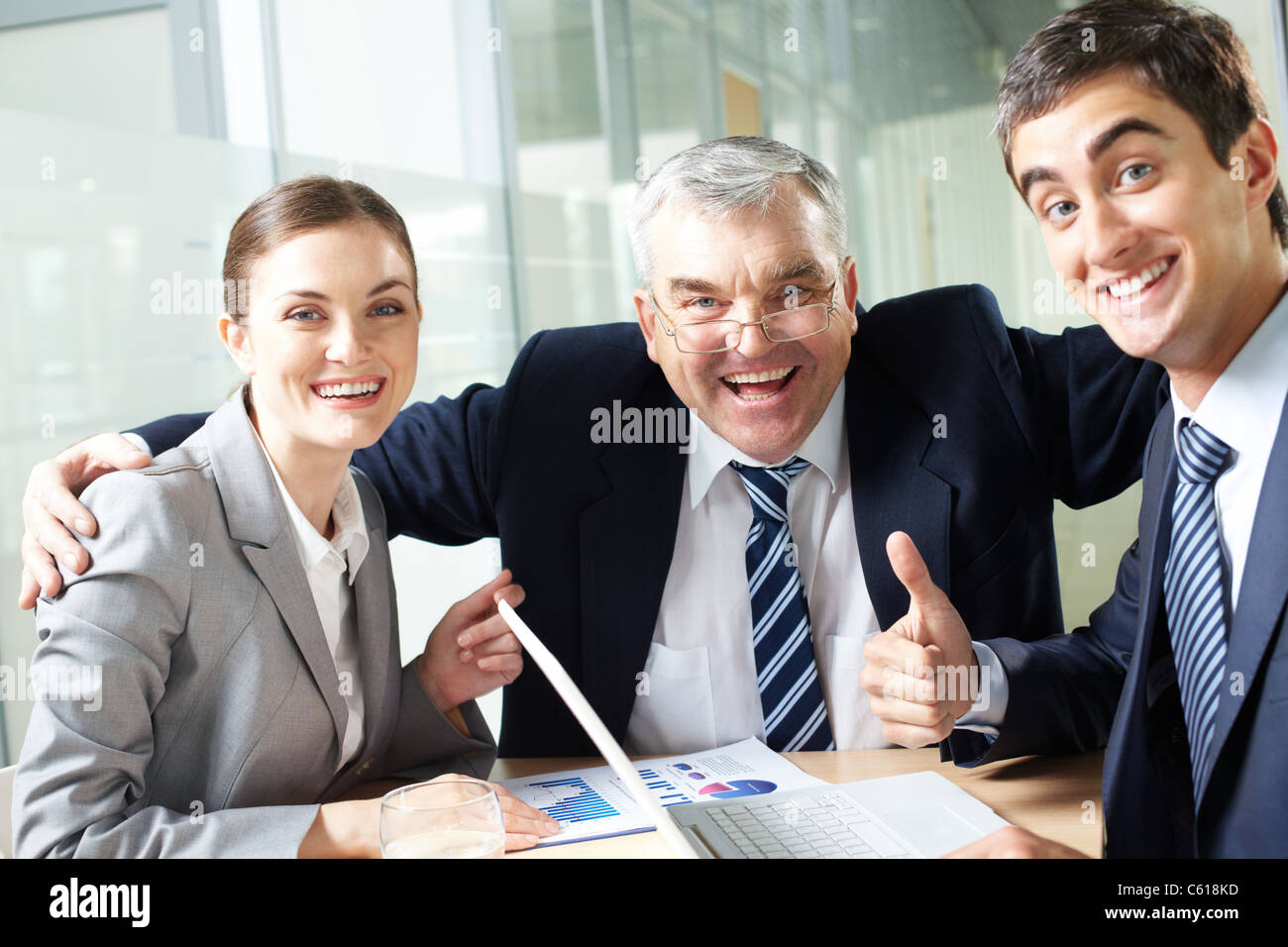 Portrait of joyful business group showing their gladness and looking at camera Stock Photo