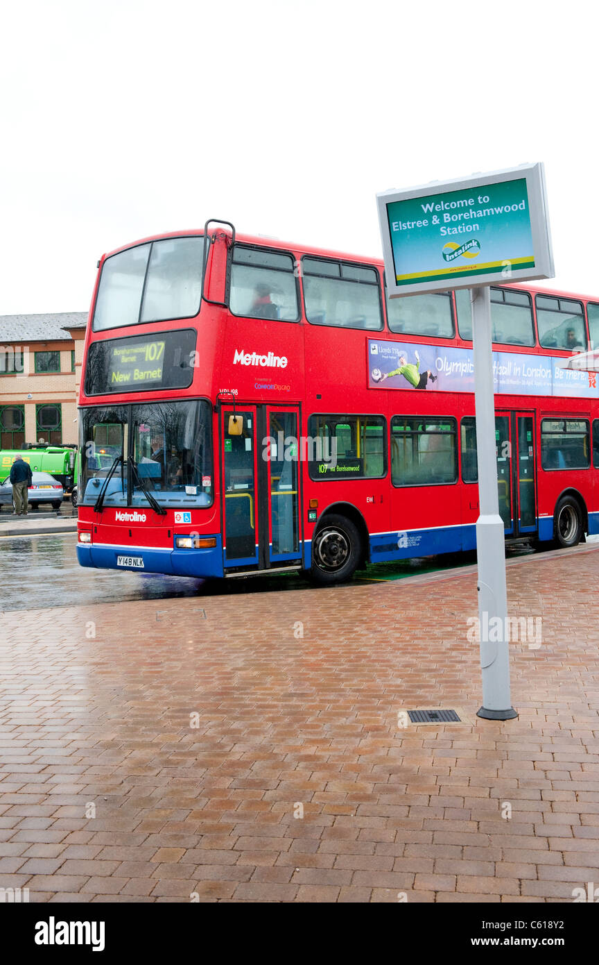 Red double decker bus in Metroline livery waiting at a bus stop at Elstree and Borehamwood Station. Stock Photo