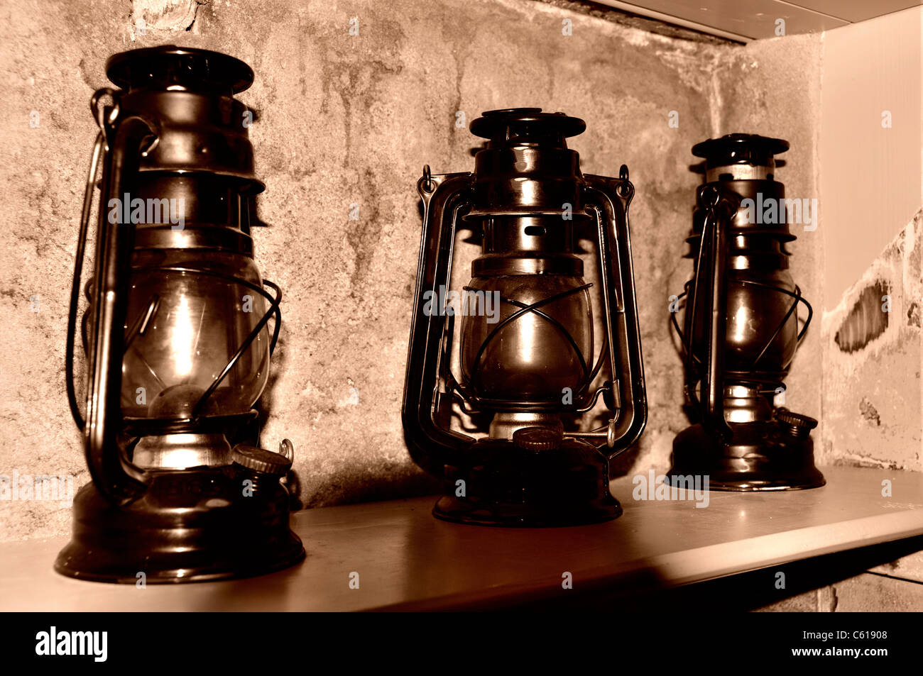 Three Storm oil lamps on a shelf Stock Photo