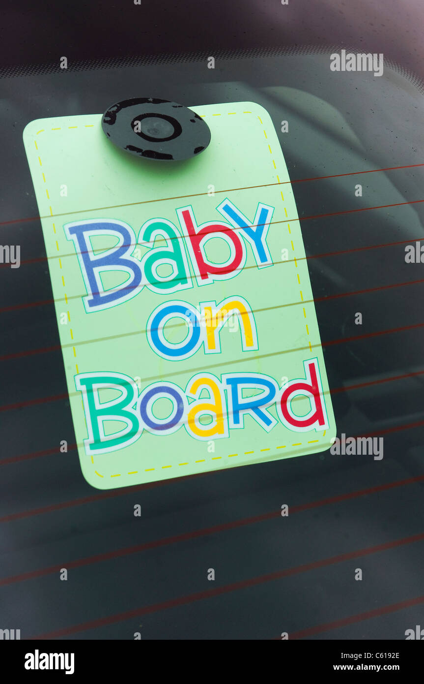 Baby on board sign in the back of a car window. Stock Photo