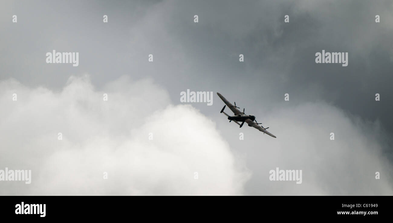 A second world war Avro Lancaster bomber, part of the Battle of Britain flight, UK - in flight, grey black clouds Stock Photo