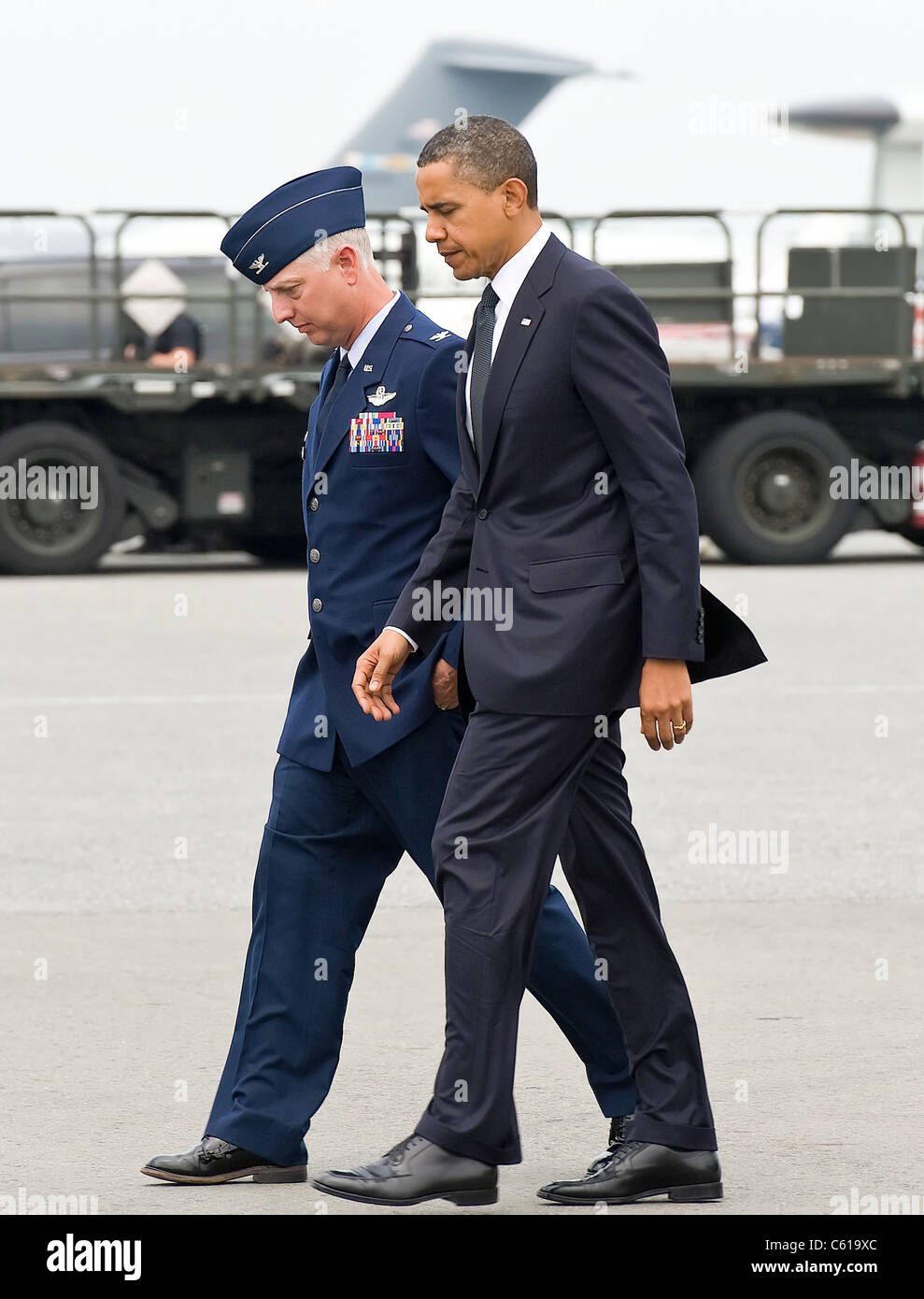 President Barack Obama is escorted by Col. Mark Camerer, 436th Airlift Wing commander at Dover Air Force Base, Del., Aug. 9, 2011. The president came to Dover to pay respect to 30 fallen U.S. servicemembers, seven Afghan soldiers and a civilian interpreter at a dignified transfer. (U.S. Air Force photo/Roland Balik) Stock Photo