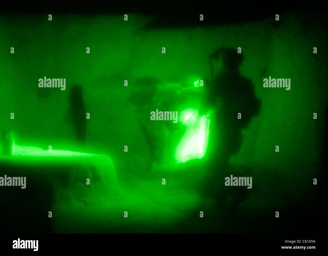 A U.S. Navy SEAL and an Afghan commando utilize flashlights while searching a compound during a village clearing operation in Shah Wali Kot district, Kandahar province, Afghanistan, June 7, 2011. Operations such as these are conducted in order to deny Taliban influence and promote the Government of Afghanistan, while providing security and stability throughout the province. The SEALs are with Special Operations Task Force - South, and the commandos are with the Afghan national army?s 3rd Commando Kandak. (U.S. Army photo by Sgt. Daniel P. Shook/Released) Stock Photo