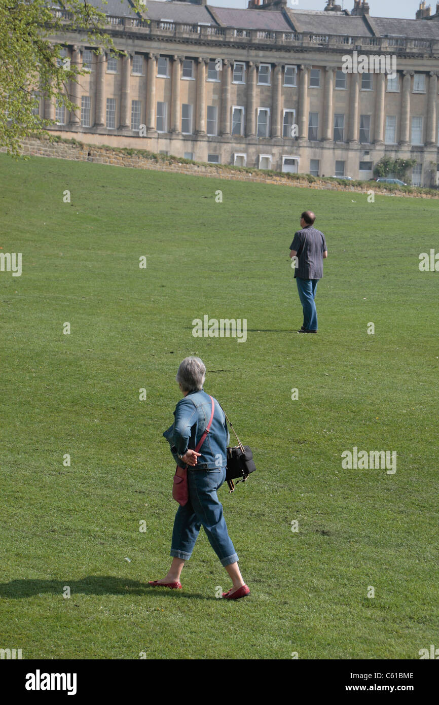 A photography widow.  The partner of an amateur photographer left holding the bags,  Royal Crescent in Bath, Somerset, England Stock Photo