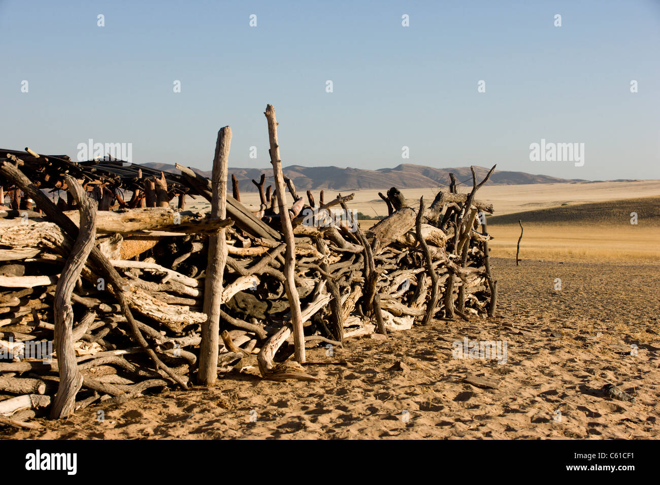 The wooden fence to the Himba village. Purros, Northern Kaokoland, Kaokoveld, Namibia. Stock Photo