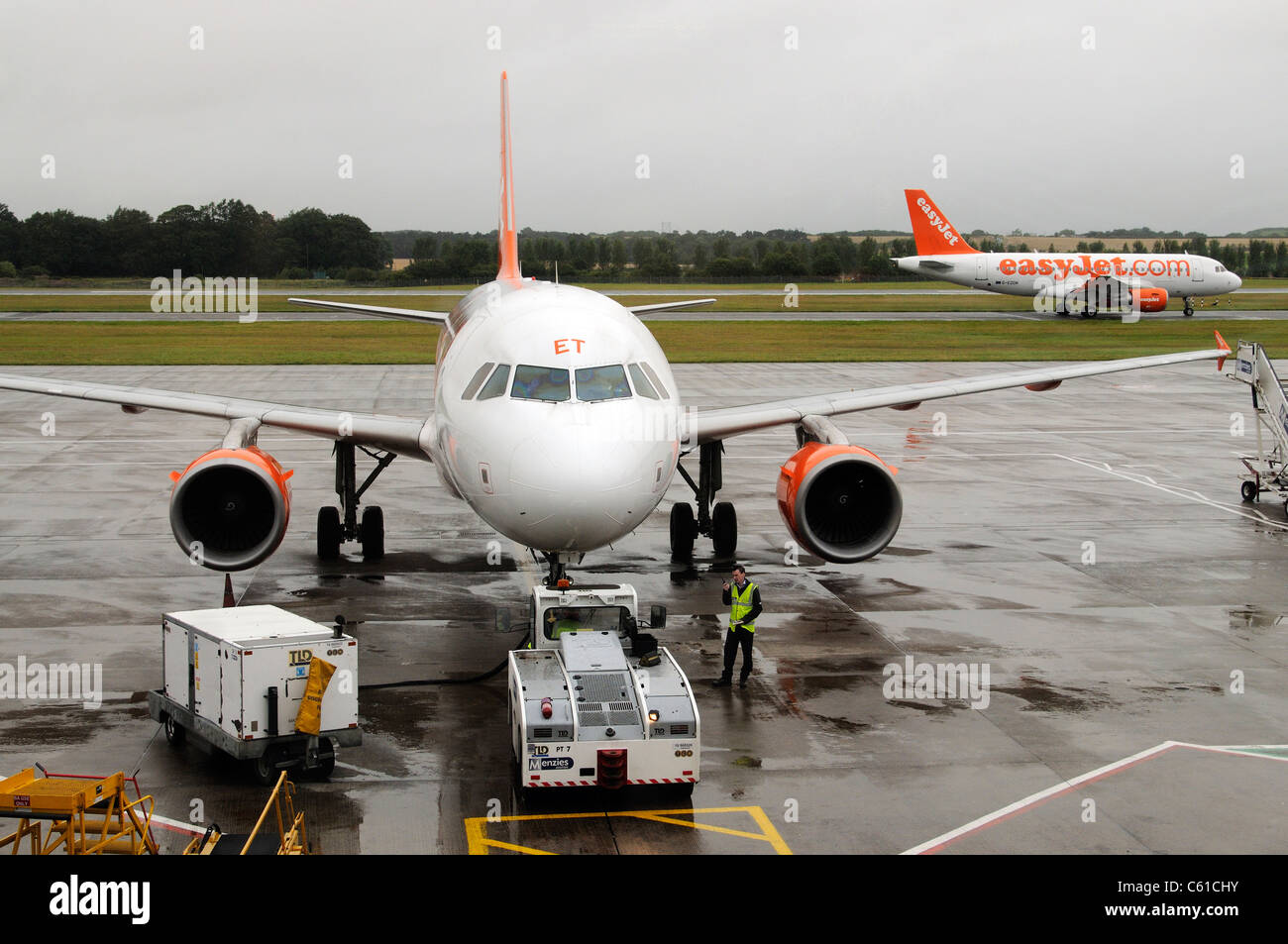 Ground support service using a pushback tractor to move an Easyjet Airbus onto the taxiway at Edinburgh Airport Scotland Stock Photo