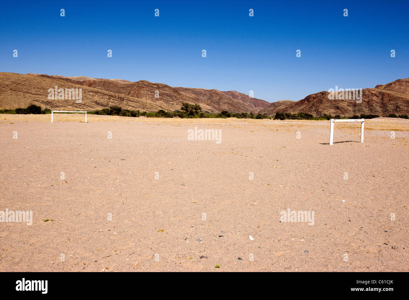 The sand football pitch belonging to Purros school. Purros, Northern Kaokoland, Kaokoveld, Namibia. Stock Photo