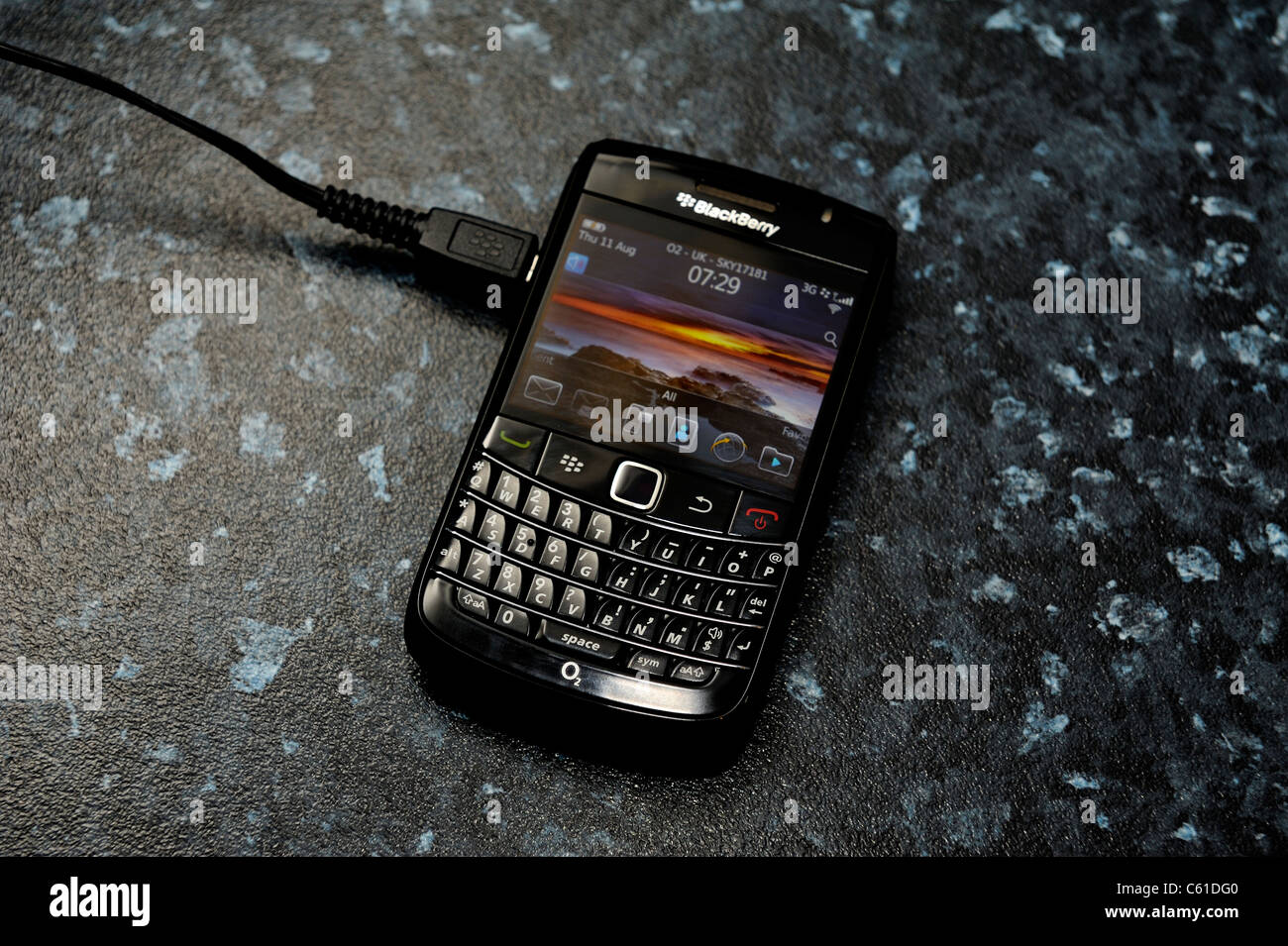 blackberry bold mobile phone on charge Stock Photo