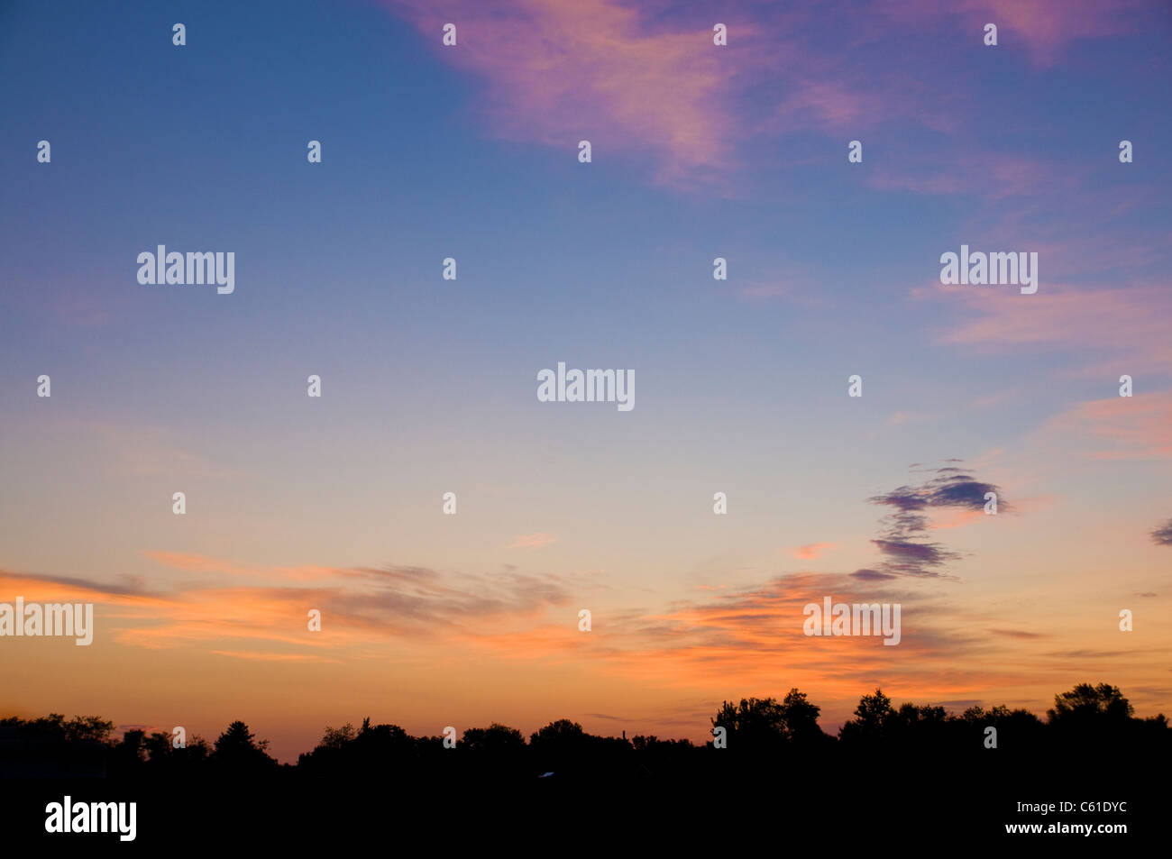 Orange clouds over the horizon at sunrise Stock Photo - Alamy